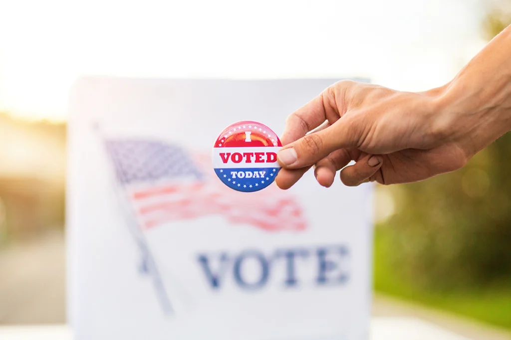 Hand with "I voted today" badge